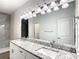 Double vanity bathroom with granite countertop and modern lighting at 368 Munoz St, Port Charlotte, FL 33953