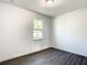 Simple bedroom with window and wood-look flooring at 368 Munoz St, Port Charlotte, FL 33953