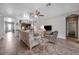 Living room with open floor plan, view of kitchen and entryway, comfortable seating at 6722 Wild Elm Ct, Wesley Chapel, FL 33545