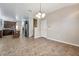 Spacious dining area with tile floors and view into the kitchen at 6722 Wild Elm Ct, Wesley Chapel, FL 33545