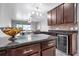Spacious kitchen with dark wood cabinets, granite counters, and stainless steel appliances at 6722 Wild Elm Ct, Wesley Chapel, FL 33545