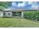 Home's backyard with patio and well-manicured lawn at 6722 Wild Elm Ct, Wesley Chapel, FL 33545