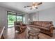 Bright living room with patio door leading to backyard, comfortable seating at 6722 Wild Elm Ct, Wesley Chapel, FL 33545