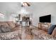 Open concept living area with comfortable seating and large TV at 6722 Wild Elm Ct, Wesley Chapel, FL 33545