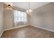Bright dining room features tile floors and a window with sheer curtains at 6722 Wild Elm Ct, Wesley Chapel, FL 33545