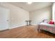 Well-lit bedroom featuring wood floors and a window at 6722 Wild Elm Ct, Wesley Chapel, FL 33545
