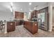 Modern kitchen with dark wood cabinets, granite countertops, and stainless steel appliances at 6722 Wild Elm Ct, Wesley Chapel, FL 33545