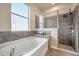 Bathroom with garden tub, shower, and window at 6722 Wild Elm Ct, Wesley Chapel, FL 33545