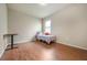 Bright bedroom with wood floors, window, and a desk at 6722 Wild Elm Ct, Wesley Chapel, FL 33545