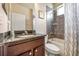 Small bathroom with granite countertop, tub shower combo, and dark wood cabinets at 6722 Wild Elm Ct, Wesley Chapel, FL 33545