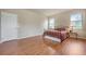 Bedroom with wood flooring, a bed, and an ensuite bathroom at 6722 Wild Elm Ct, Wesley Chapel, FL 33545
