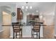 Kitchen with breakfast bar, dark wood cabinets and granite countertops at 6722 Wild Elm Ct, Wesley Chapel, FL 33545