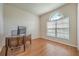 Home office with wood desk, hardwood floors, and an arched window at 6722 Wild Elm Ct, Wesley Chapel, FL 33545