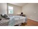 Bedroom with wood flooring, a bed, and a workspace at 6722 Wild Elm Ct, Wesley Chapel, FL 33545