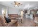 Open concept living room with kitchen view, tiled floors, and comfortable seating at 6722 Wild Elm Ct, Wesley Chapel, FL 33545