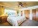 Bright bedroom with a ceiling fan, neutral carpet, and lots of natural light at 3240 San Mateo St, Clearwater, FL 33759