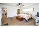 Comfortable bedroom with a ceiling fan, a view to the bathroom, and a chest at 3240 San Mateo St, Clearwater, FL 33759