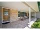 The charming covered front porch features stone details and tile flooring, perfect for outdoor relaxation at 3240 San Mateo St, Clearwater, FL 33759