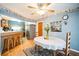 Dining area with wood floors, traditional decor, and adjacent kitchen access at 3240 San Mateo St, Clearwater, FL 33759