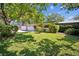 The property features a well-maintained lawn, an attached garage, and mature trees adding to its appeal at 3240 San Mateo St, Clearwater, FL 33759
