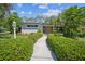 Charming single-story home featuring a well-manicured lawn and welcoming walkway leading to the front door at 3240 San Mateo St, Clearwater, FL 33759