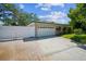 The garage is attached to the home and is accessed by a spacious driveway and a white privacy fence at 3240 San Mateo St, Clearwater, FL 33759