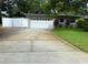 The home has an attached garage which is accessed by a spacious driveway and a white privacy fence at 3240 San Mateo St, Clearwater, FL 33759