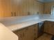 An upgraded kitchen features bright countertops, white backsplash, and wood-look cabinets with dark hardware at 3240 San Mateo St, Clearwater, FL 33759