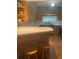 A spacious kitchen with bar seating features updated counters, stainless appliances, and wood cabinets at 3240 San Mateo St, Clearwater, FL 33759