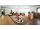 Open living room with hardwood-style flooring, neutral carpet, and a large window at 3240 San Mateo St, Clearwater, FL 33759