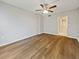 Bright bedroom with wood-look floors and access to bathroom at 612 Bird Bay S Dr # 113, Venice, FL 34285