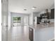 Open concept kitchen with island and view of living and patio areas at 12120 Barnsley Reserve Pl, Gibsonton, FL 33534