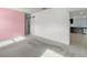 Bedroom with pink accent wall and view of kitchen at 12120 Barnsley Reserve Pl, Gibsonton, FL 33534