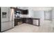 Modern kitchen with dark wood cabinets and stainless steel appliances at 12120 Barnsley Reserve Pl, Gibsonton, FL 33534