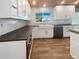 Modern kitchen with white shaker cabinets and dark countertops at 1019 Deer Run, Venice, FL 34293