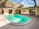 Inviting kidney-shaped pool with covered patio at 1019 Deer Run, Venice, FL 34293