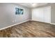 Well-lit bedroom with wood-look floors and ample closet space at 1019 Deer Run, Venice, FL 34293
