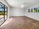 Spacious bedroom with carpet flooring and sliding glass doors at 1019 Deer Run, Venice, FL 34293