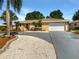 Single-story home with a large driveway and mature landscaping at 1019 Deer Run, Venice, FL 34293