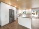 Modern kitchen with white cabinets, concrete island, and wood floors at 1019 Deer Run, Venice, FL 34293