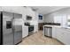 Modern kitchen with stainless steel appliances and white cabinetry at 7822 Red Hickory Pl, Riverview, FL 33578