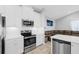 Kitchen with stainless steel appliances and white cabinets at 7822 Red Hickory Pl, Riverview, FL 33578