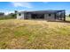 Backyard with a screened in pool, black chain link fence, and well-kept landscaping at 9308 San Bernandino Ave, Englewood, FL 34224