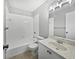 Cozy bathroom featuring a vanity with sink, tiled floors, tub, and shower combo at 9308 San Bernandino Ave, Englewood, FL 34224