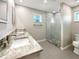 Modern bathroom featuring double sinks, granite countertops, and a glass-enclosed shower at 9308 San Bernandino Ave, Englewood, FL 34224
