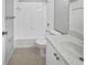 A full bathroom shows a vanity with sink, tiled floors, tub, and shower combo at 9308 San Bernandino Ave, Englewood, FL 34224