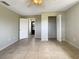 Neutral bedroom with tile floor, ceiling fan and closet at 9308 San Bernandino Ave, Englewood, FL 34224