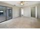 Spacious bedroom with sliding glass doors, tile floors, ceiling fan, and ample closet space at 9308 San Bernandino Ave, Englewood, FL 34224