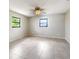 Bedroom with two windows, tile floors, neutral paint and ceiling fan at 9308 San Bernandino Ave, Englewood, FL 34224