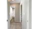 Hallway with tile flooring and views into bedrooms and bathrooms at 9308 San Bernandino Ave, Englewood, FL 34224